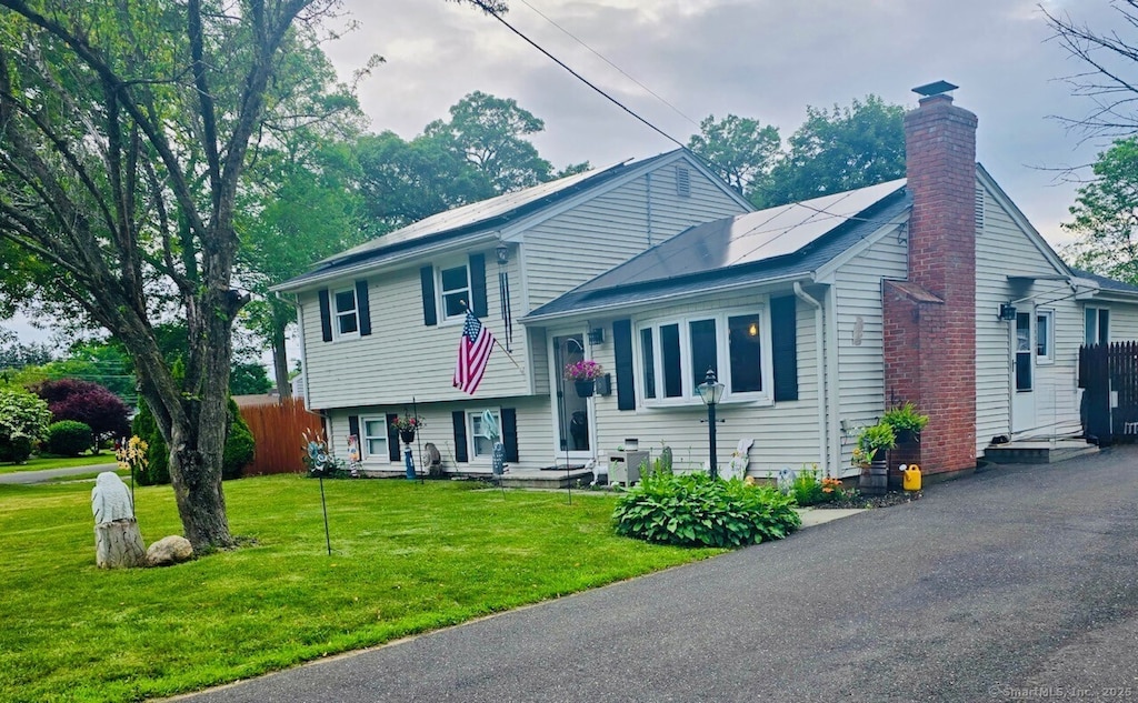 6 Pinecrest Dr, Plainville, CT 06062 - split level home with a chimney and solar panels