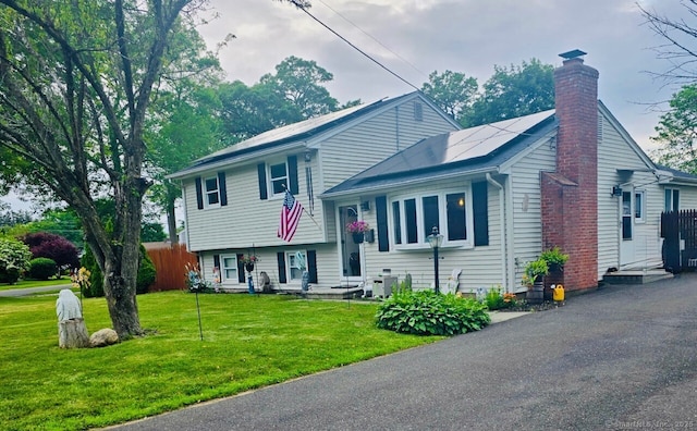 6 Pinecrest Dr, Plainville, CT 06062 - split level home with a chimney and solar panels