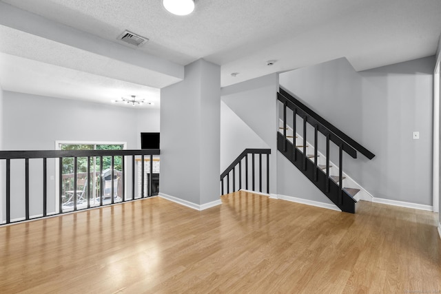 410 Farmington Ave Apt M2, New Britain, CT 06053 - unfurnished room with wood finished floors and a textured ceiling
