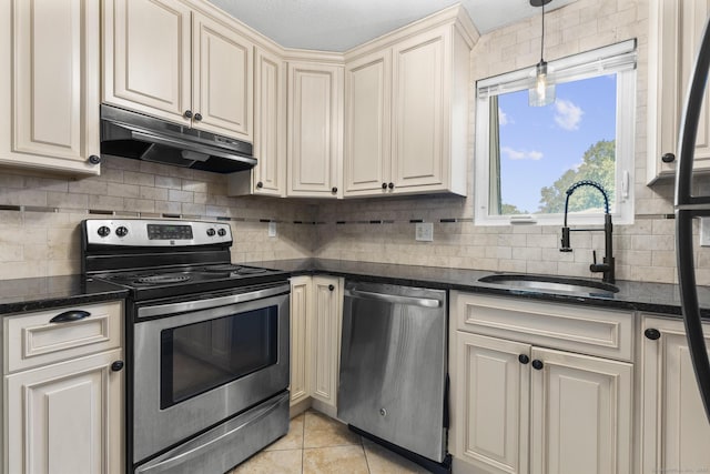 410 Farmington Ave Apt M2, New Britain, CT 06053 - kitchen with appliances with stainless steel finishes, under cabinet range hood, cream cabinets, backsplash, and light tile patterned flooring