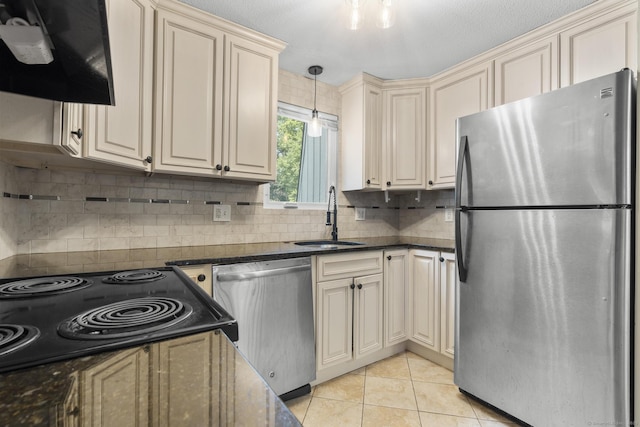 410 Farmington Ave Apt M2, New Britain, CT 06053 - kitchen featuring appliances with stainless steel finishes, cream cabinetry, light tile patterned floors, exhaust hood, and tasteful backsplash