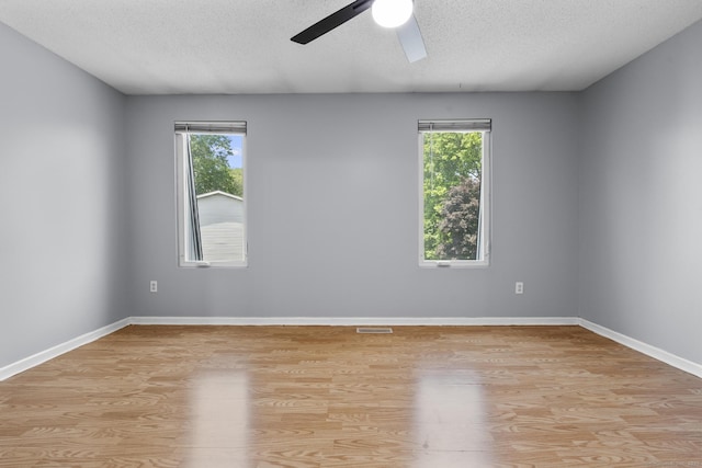 410 Farmington Ave Apt M2, New Britain, CT 06053 - unfurnished room with ceiling fan, healthy amount of natural light, light wood-style floors, and a textured ceiling