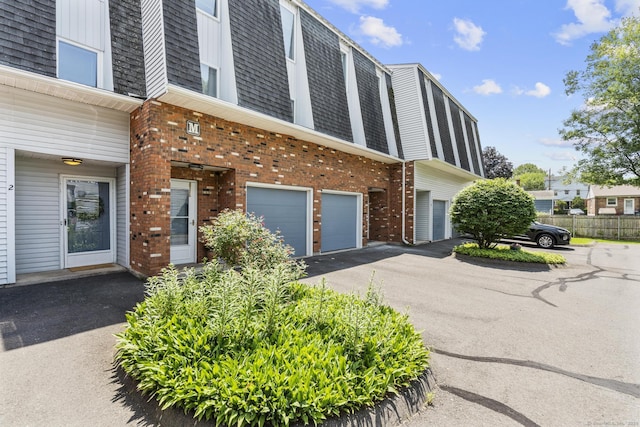 410 Farmington Ave Apt M2, New Britain, CT 06053 - view of building exterior with an attached garage and driveway