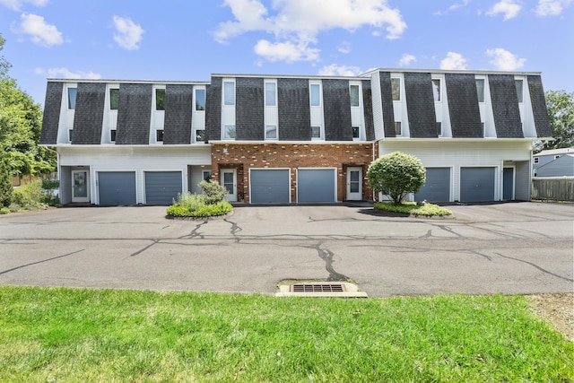410 Farmington Ave Apt M2, New Britain, CT 06053 - townhome / multi-family property featuring a shingled roof, mansard roof, and an attached garage