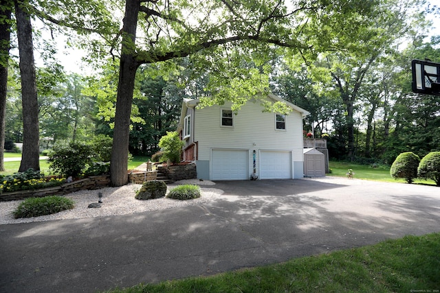 21 Berle Rd, South Windsor, CT 06074 - view of home's exterior featuring a garage, driveway, and a shed
