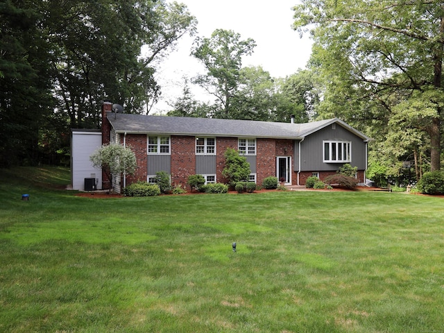 21 Berle Rd, South Windsor, CT 06074 - split foyer home with brick siding, a front lawn, and a chimney