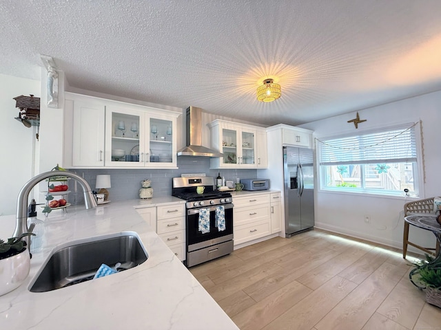 5 Mansfield Grove Rd Apt 146, East Haven, CT 06512 - kitchen with stainless steel appliances, wall chimney exhaust hood, white cabinetry, decorative backsplash, and a textured ceiling