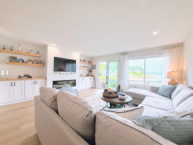 5 Mansfield Grove Rd Apt 146, East Haven, CT 06512 - living area featuring a textured ceiling, light wood finished floors, a fireplace, and recessed lighting