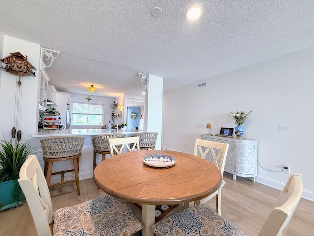 5 Mansfield Grove Rd Apt 146, East Haven, CT 06512 - dining space featuring light wood-style flooring and a textured ceiling