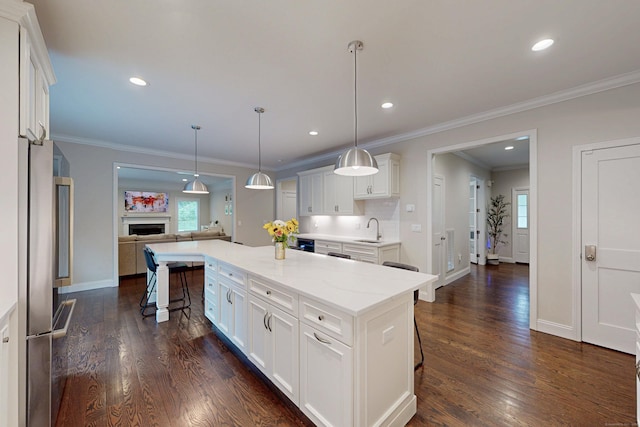 13 Spruce Ridge Dr, New Fairfield, CT 06812 - kitchen with dark wood finished floors, a breakfast bar area, open floor plan, white cabinetry, and plenty of natural light