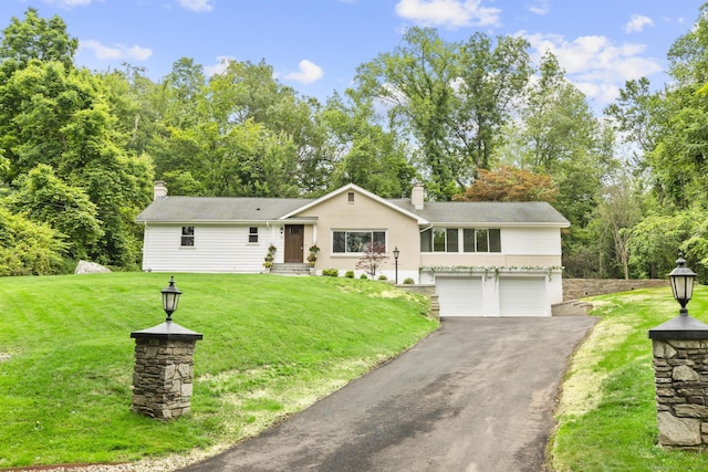 14 Pine Tree Ln, Avon, CT 06001 - view of front of house featuring a chimney, an attached garage, asphalt driveway, and a front yard