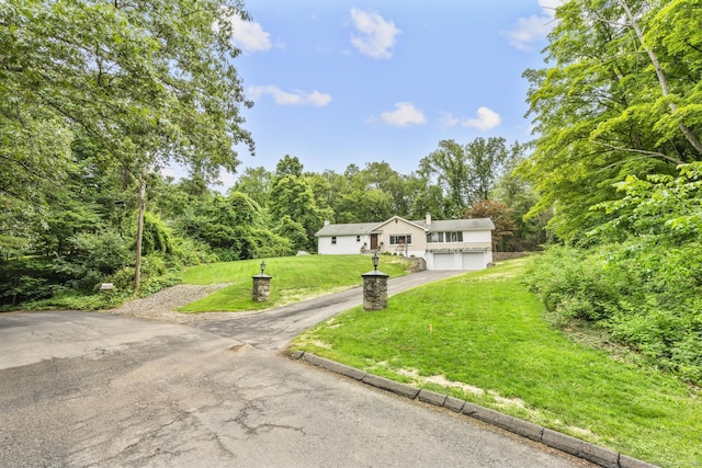 14 Pine Tree Ln, Avon, CT 06001 - view of front of home with asphalt driveway and a front yard