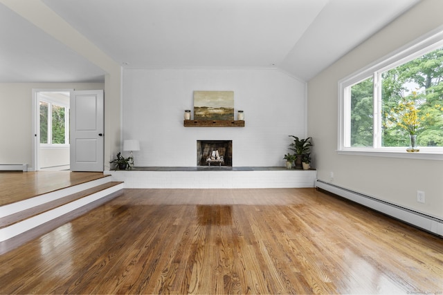 14 Pine Tree Ln, Avon, CT 06001 - unfurnished living room with baseboard heating, vaulted ceiling, a fireplace, wood finished floors, and a baseboard heating unit