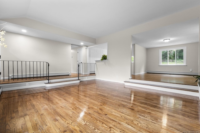 14 Pine Tree Ln, Avon, CT 06001 - empty room with a baseboard heating unit, wood finished floors, and vaulted ceiling