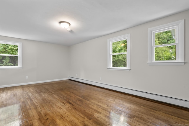 14 Pine Tree Ln, Avon, CT 06001 - spare room featuring baseboard heating and wood finished floors
