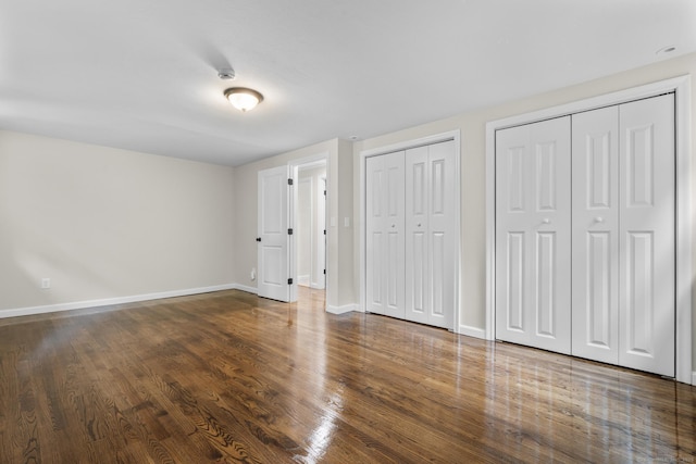 14 Pine Tree Ln, Avon, CT 06001 - unfurnished bedroom featuring multiple closets and wood finished floors