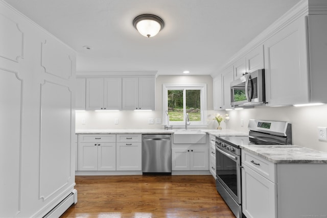 14 Pine Tree Ln, Avon, CT 06001 - kitchen with stainless steel appliances, baseboard heating, white cabinetry, wood finished floors, and recessed lighting