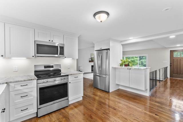 14 Pine Tree Ln, Avon, CT 06001 - kitchen with stainless steel appliances, light wood-style floors, white cabinets, light stone counters, and recessed lighting