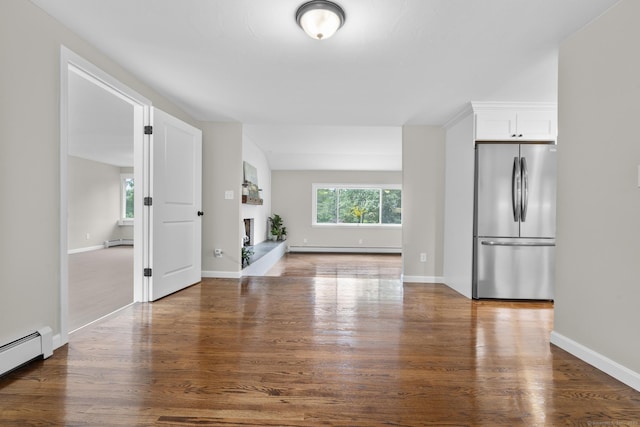 14 Pine Tree Ln, Avon, CT 06001 - unfurnished living room with baseboard heating, a baseboard heating unit, wood finished floors, and a fireplace with raised hearth