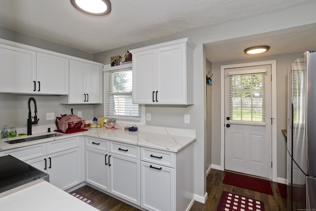 6 Weymouth Dr, Enfield, CT 06082 - kitchen featuring freestanding refrigerator, white cabinetry, dark wood finished floors, light stone counters, and stove