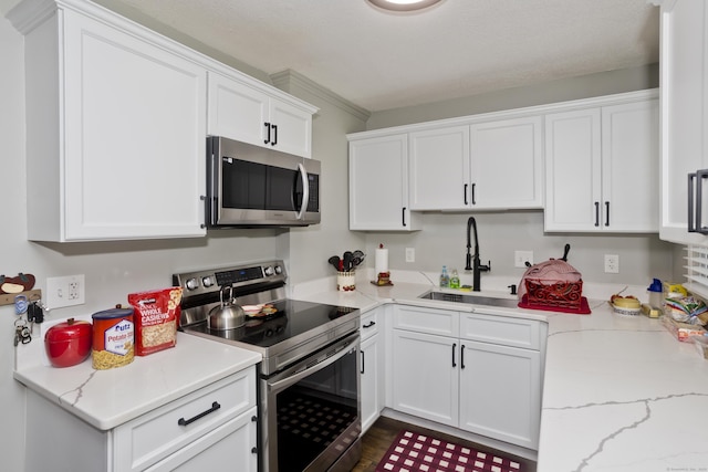 6 Weymouth Dr, Enfield, CT 06082 - kitchen with stainless steel appliances, white cabinets, light stone counters, and dark wood finished floors