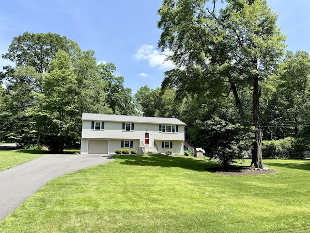 37 Pine Hill Rd, Tolland, CT 06084 - split foyer home with asphalt driveway, a garage, and a front lawn