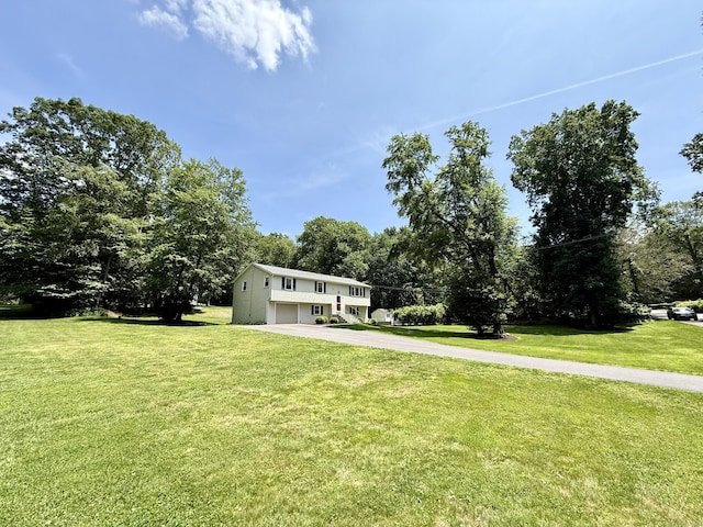 37 Pine Hill Rd, Tolland, CT 06084 - view of front facade featuring driveway, an attached garage, a front lawn, and view of wooded area