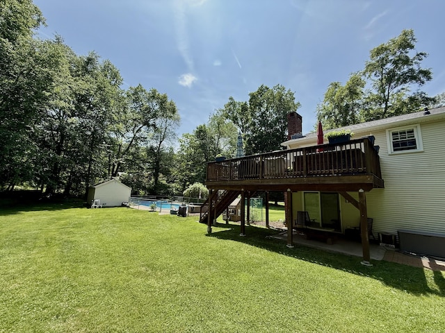 37 Pine Hill Rd, Tolland, CT 06084 - view of grassy yard featuring a wooden deck, stairs, a patio, an outdoor pool, and a storage unit