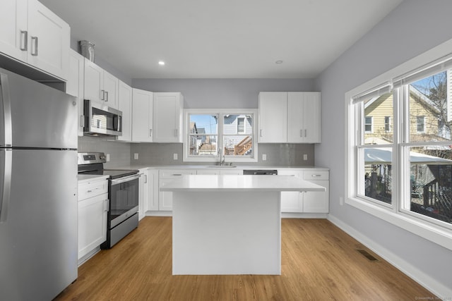 195 Arctic St, Bridgeport, CT 06608 - kitchen featuring stainless steel appliances, light countertops, tasteful backsplash, light wood finished floors, and recessed lighting