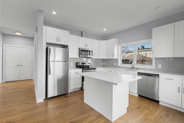 195 Arctic St, Bridgeport, CT 06608 - kitchen with appliances with stainless steel finishes, light countertops, white cabinetry, and recessed lighting