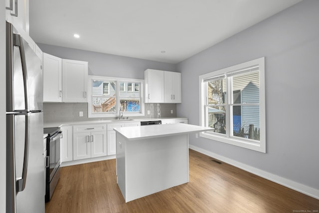 195 Arctic St, Bridgeport, CT 06608 - kitchen featuring stainless steel appliances, light countertops, backsplash, healthy amount of natural light, and recessed lighting