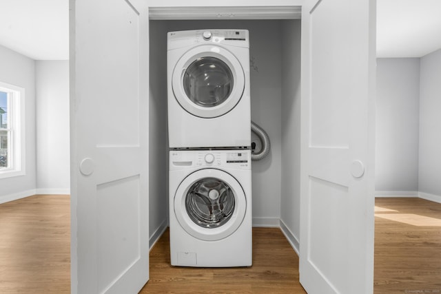 195 Arctic St, Bridgeport, CT 06608 - laundry area with stacked washing machine and dryer and wood finished floors