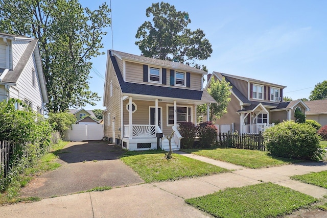 283 Third Ave, West Haven, CT 06516 - view of front facade featuring a porch, asphalt driveway, and a detached garage