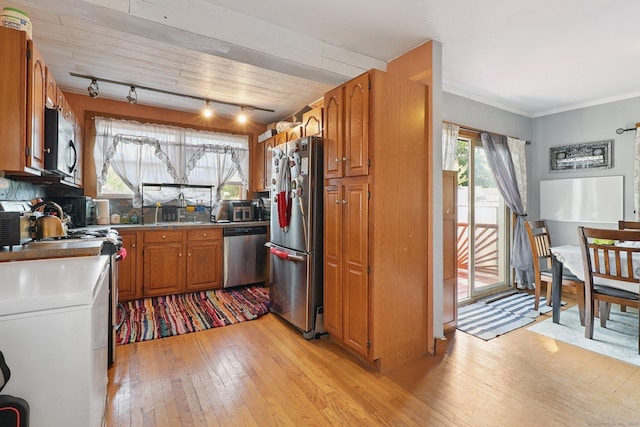 283 Third Ave, West Haven, CT 06516 - kitchen featuring appliances with stainless steel finishes, light wood-style flooring, brown cabinetry, track lighting, and light countertops