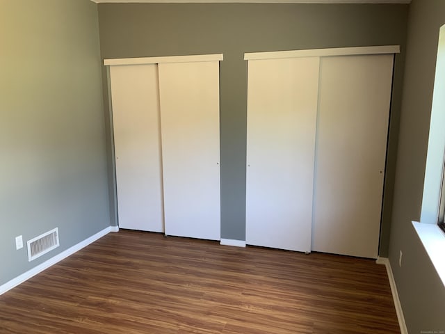 158 Webster Ct Unit 158, Newington, CT 06111 - unfurnished bedroom featuring two closets and wood finished floors