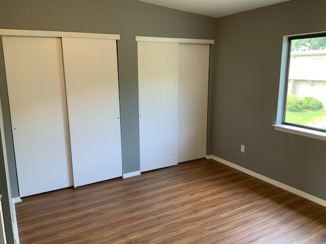 158 Webster Ct Unit 158, Newington, CT 06111 - unfurnished bedroom featuring multiple closets and wood finished floors