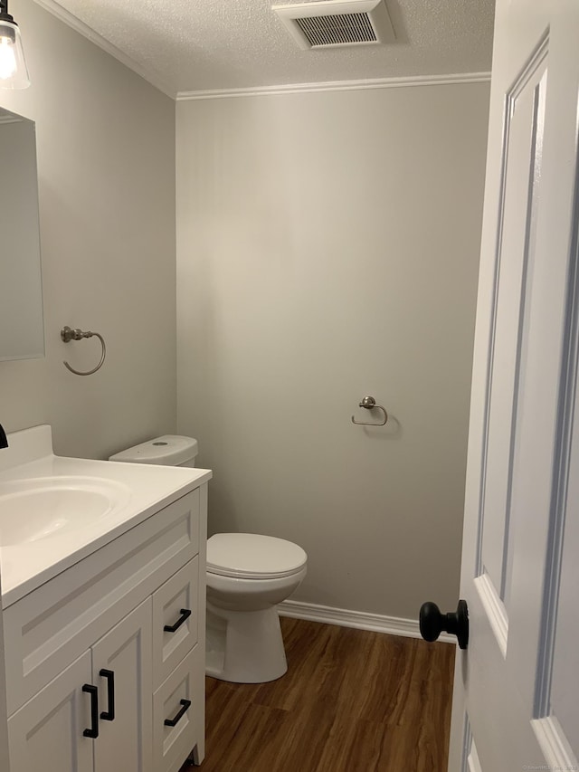 158 Webster Ct Unit 158, Newington, CT 06111 - half bathroom featuring wood finished floors, vanity, a textured ceiling, and ornamental molding
