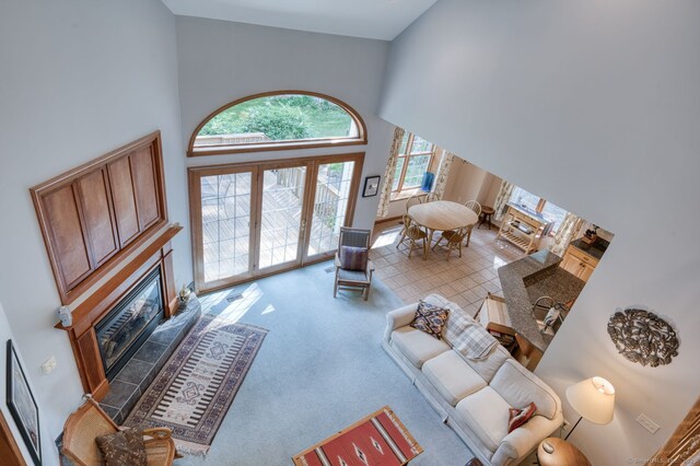 1047 Merrow Rd, Coventry, CT 06238 - carpeted living room featuring a glass covered fireplace and high vaulted ceiling