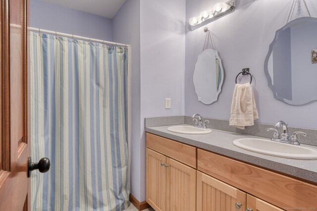 1047 Merrow Rd, Coventry, CT 06238 - bathroom featuring double vanity and a shower with shower curtain