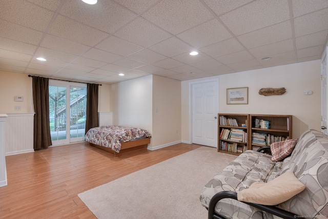 1047 Merrow Rd, Coventry, CT 06238 - bedroom with light wood-style floors, a paneled ceiling, access to exterior, a wainscoted wall, and recessed lighting