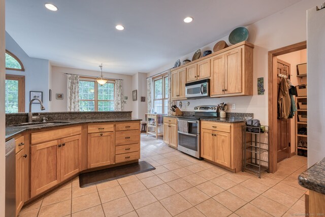 1047 Merrow Rd, Coventry, CT 06238 - kitchen featuring stainless steel appliances, recessed lighting, light tile patterned floors, dark stone countertops, and pendant lighting
