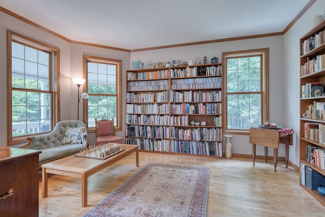 1047 Merrow Rd, Coventry, CT 06238 - living area with plenty of natural light, hardwood / wood-style floors, crown molding, and bookshelves