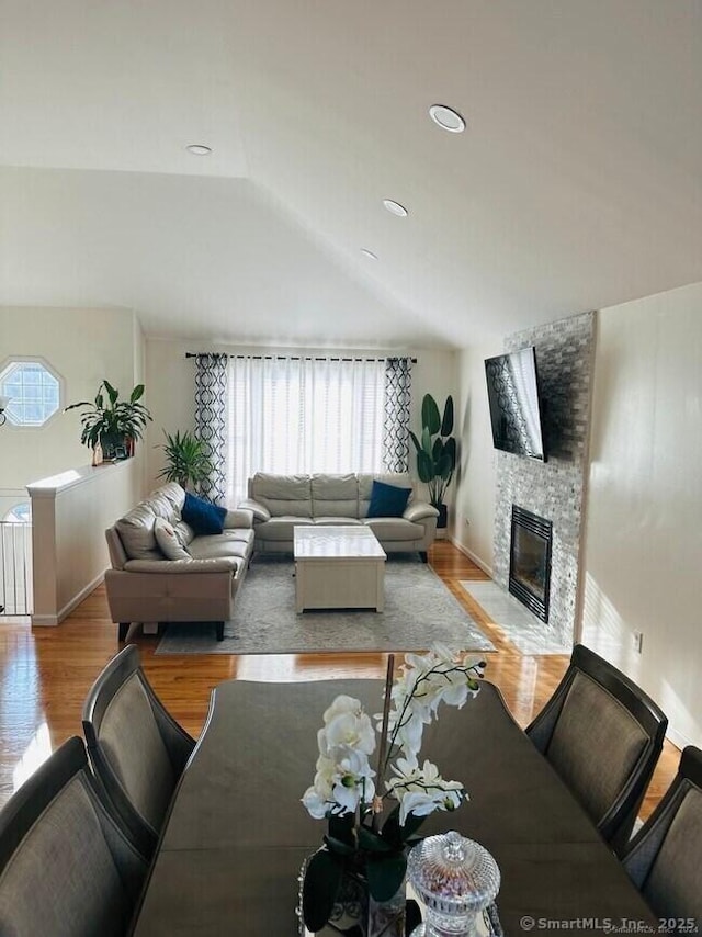 470 Nott St, Wethersfield, CT 06109 - living room featuring lofted ceiling, a stone fireplace, and wood finished floors
