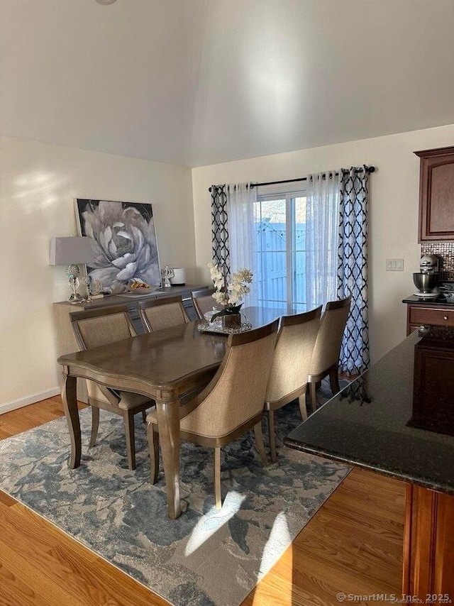 470 Nott St, Wethersfield, CT 06109 - dining area featuring wood finished floors and vaulted ceiling