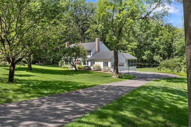 78 Carriage Rd, Wilton, CT 06897 - view of front of house featuring asphalt driveway, a chimney, a front yard, an attached garage, and roof with shingles