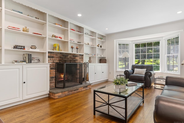 78 Carriage Rd, Wilton, CT 06897 - living room with wood finished floors, crown molding, a fireplace, recessed lighting, and built in shelves