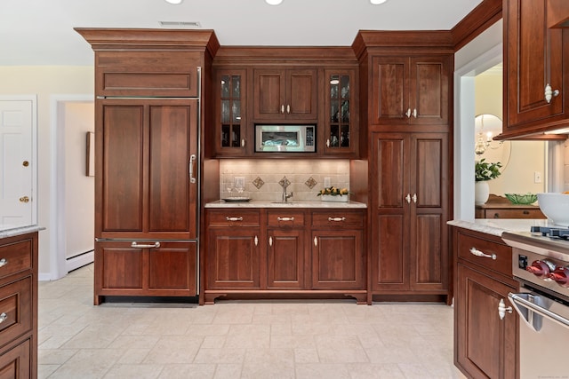 78 Carriage Rd, Wilton, CT 06897 - kitchen featuring appliances with stainless steel finishes, tasteful backsplash, glass insert cabinets, a baseboard radiator, and light stone countertops