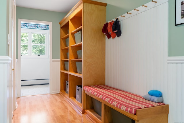 78 Carriage Rd, Wilton, CT 06897 - mudroom with baseboard heating, a wainscoted wall, wood finished floors, and a decorative wall
