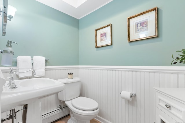 78 Carriage Rd, Wilton, CT 06897 - half bathroom featuring baseboard heating, a wainscoted wall, and ornamental molding