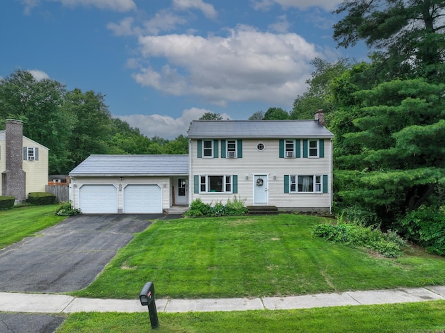 17 Plainfield St, Enfield, CT 06082 - colonial inspired home with an attached garage, asphalt driveway, a chimney, and a front yard